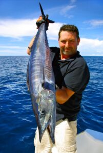 a man holding the fish he caught